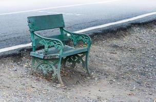 Lonely metal green bench photo