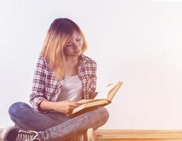 Woman reading books and lying in sofa at home. photo