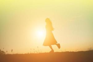 silhouette of a young woman standing alone photo