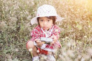 little girl photographs flower outdoor photo