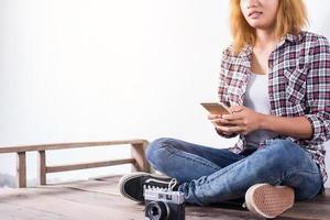 Young beautiful hipster woman with an old retro camera. photo