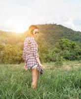 Vintage of beautiful women photography standing hand holding retro camera with sunrise,dream soft style photo