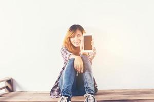 Close-up of a woman typing on mobile phone isolated on white background,Woman's hand holding smartphone. photo