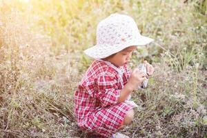 little girl photographs flower outdoor photo