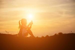 kid silhouette,Moments of the child's joy. On the Nature sunset photo