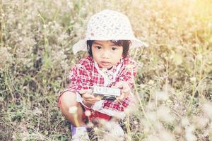 little girl photographs flower outdoor photo