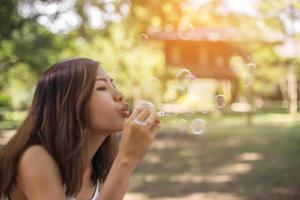 a beautiful woman blowing bubbles photo