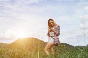 Young Hipster Woman with retro camera taking shot outdoor landscape ,Lifestyle mountain nature on background. photo