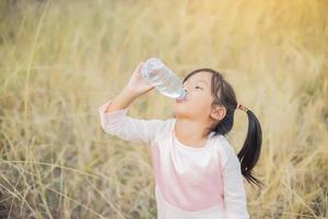 Little girl drinking water. photo