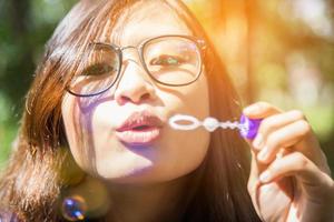 a beautiful woman blowing bubbles photo