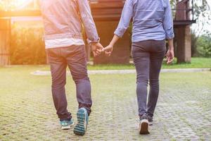 A young couple holding hands. In Nature sunrise photo