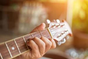 Close up man's hand playing the guitar. photo