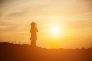 kid silhouette,Moments of the child's joy. On the Nature sunset photo