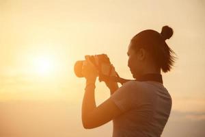 silhouette photographer woman in the sunset photo