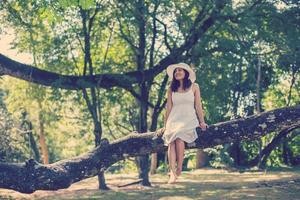 Young teen girl sitting on tree photo
