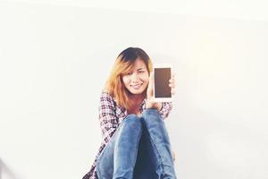 Close-up of a woman typing on mobile phone isolated on white background,Woman's hand holding smartphone. photo