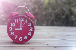 alarm clock with abstract nature bokeh blur background. photo