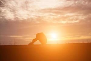 Sad and depressed woman sitting alone photo