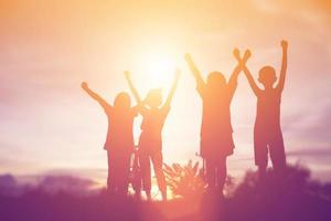 silhouette of a happy children and happy time sunset photo