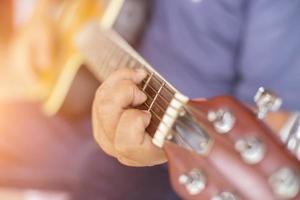 Close up man's hand playing the guitar. photo