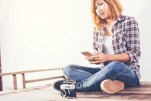 Young beautiful hipster woman with an old retro camera. photo