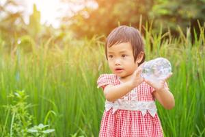 Lovely little girl drinking water photo