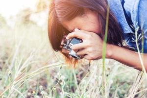 Vintage of beautiful women photography standing hand holding retro camera with sunrise,dream soft style photo