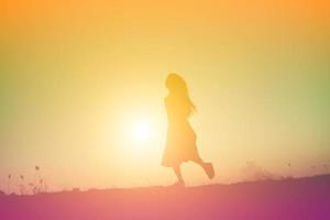 silhouette of a young woman standing alone photo