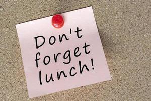 Sticky note with word don't forget lunch. Reminder and appointment concept. photo