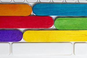 yellow and red color wooden stick on wooden desk.Directly above. Copy space. photo