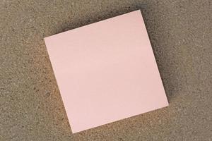 Sticky note on brown paper background. Directly above. Flat lay. photo