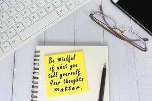 Motivational and inspirational quote written on the adhesive note photo