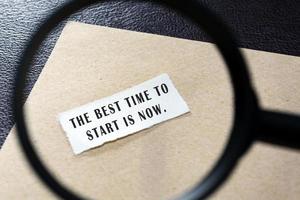 Motivational and inspirational quote on white paper with brown envelope on wooden desk. photo