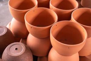 Stacks of orange various terracotta pots for plants for sale at a garden store. photo