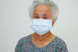 Asian elderly woman patient wearing a mask for protect Covid-19 Coronavirus. photo