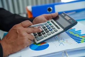 Businessman working and analysis with statistic graph in office. photo