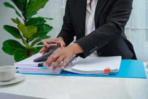 Businessman working and prepare paperwork report data to analysis information in file binder at office. photo