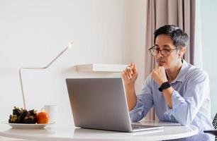 Portrait of asian businessman working on laptop. photo