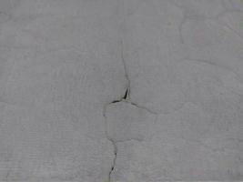 Background of gray patterned texture of cement wall. Cracked cement wall.