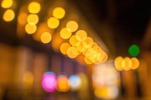 Blurred Night city bokeh glows light background empty. Banner candlelight shines yellow gold glitter abstract. Design background Celebration photo