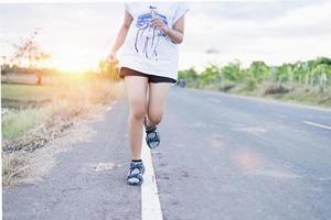 mujer trotando por la tarde o por la mañana, entrenando para descansar y recuperarse. foto