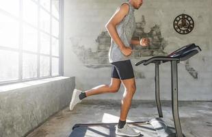 Legs of healthy people exercising on a treadmill. photo