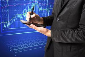 Digital online marketing Businessman using tablet and sales data graph growth analysis on modern interface icons about strategy. Solution analysis and content development. photo