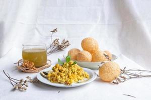 Homemade pani puri, Golgappa Indian snack on cotton calico background photo