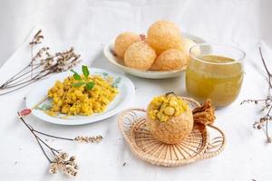 Homemade pani puri, Golgappa Indian snack on cotton calico background photo