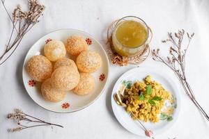 Homemade pani puri, Golgappa Indian snack on cotton calico background photo