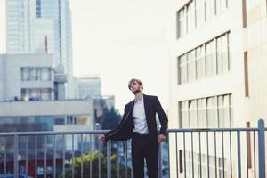Free man in suit standing on roof photo