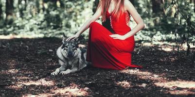 woman with her wolf dog in forest photo