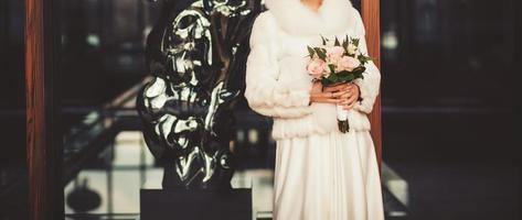 beautiful bride in a fur coat photo