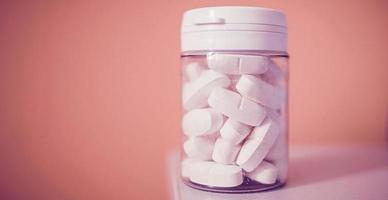 Pill bottle on colorful background photo